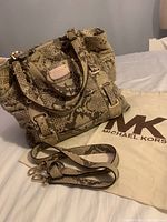 Photo showing vintage Michael Kors handbag in snake print with adjustable strap and dust bag.