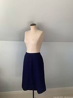 Full view of vintage royal blue wool skirt displayed on mannequin.