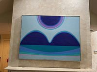 Full frontal view of framed abstract painting mounted above fireplace