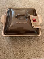 Square brown Le Creuset casserole with lid, new with tag seen from top angle