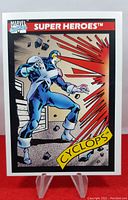 Front of the 1990 Impel Marvel Series 1 Cyclops trading card depicting Cyclops in blue costume firing optic blasts.
