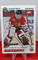 Front view of 1991-92 Upper Deck Dominik Hasek rookie hockey card showing player in red Chicago Blackhawks uniform with full goalie gear.
