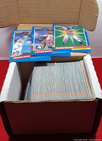 Open box showing a large quantity of 1991 Leaf Donruss baseball cards with three cards displayed on top - Gerald Perry, Lonnie Smith, and Bobby Bonilla.