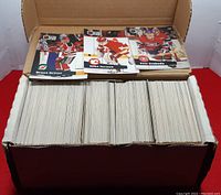 Box filled with 1991 Pro Set hockey cards featuring player cards displayed on top including Bruce Driver, Mike Vernon, Petr Svoboda.