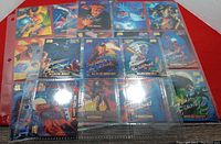 21 sleeved Marvel Masterpieces Signature Series trading cards showing characters like Domino, Black Bolt, and Daredevil with silver foil signatures visible on each card.