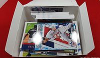 Photo showing a box containing a varied collection of 2021 Topps Opening Day baseball cards with visible players in pitching and batting photos.