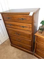 Front view of 5 drawer tall boy dresser showing drawer detail and metal pulls