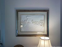 Framed textured wall art with two herons and marsh scene, showing overall condition and framing detail.