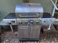 Front view of Master Chef stainless steel Elite 40 propane gas BBQ grill showing five control knobs and side burner