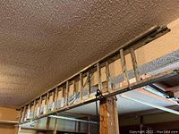 Side view of the 12-foot extendable metal ladder, showing the entire length and metal construction.