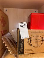 Photo of batter bowl and baker boxes with red container and Pampered Chef branding.