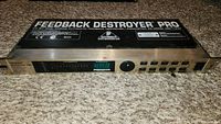 Front-panel view showing digital display, control buttons, and product labeling on the Behringer Feedback Destroyer Pro rack unit.