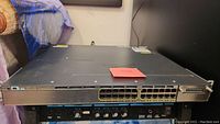 Front view of the Cisco Catalyst 3750-X switch showing 24 standard Ethernet ports and 4 uplink ports with LED indicators.