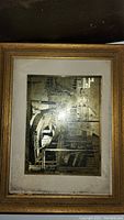 Framed Lionel Berrymore vintage street scene artwork showing sepia and gold tones inside an aged gold frame.