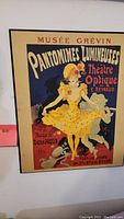 Front view of vintage framed Musée Grévin Pantomimes Lumineuses wall art poster showing full artwork and text.