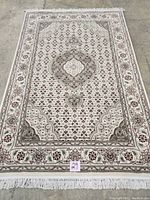 Full view of the carpet showing overall Mahi medallion and border design