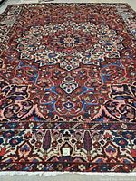 Full view of carpet showing central medallion, border and overall pattern