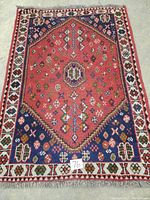 Full view of rug laid on floor showing overall pattern and condition