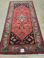 Full view of rectangular Persian hand knotted carpet showing overall pattern and color.