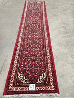 Full length view of runner on concrete floor showing overall geometry and fringe