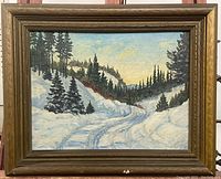 Frontal photo showing full view of the vintage oil painting with thick wooden frame, capturing the snowy mountain road scene.