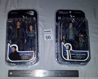 Front view of two Heroes action figures in sealed blister card packaging showing Matt Parkman and Hiro Nakamura characters with a ruler for size reference.