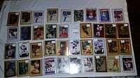 Front display of 38 NHL hockey cards, showing player images and team logos in hard plastic sleeves.