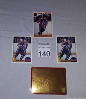 Front of the three Wayne Gretzky hockey cards: one 1985 Topps card #2 with All-Star banner, and two 1987 OPC #53 cards showing Gretzky in Edmonton Oilers uniform.