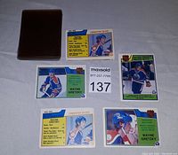 Five Wayne Gretzky hockey cards displayed face-up including card #22, #217, #212, and #215 in a fan layout next to a card sleeve and lot number.