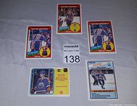 Front side of five Wayne Gretzky hockey cards from 1982 and 1984 OPC sets showing player images and identifying numbers.
