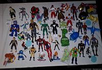 Full overview of all action figures showing the variety including Batman, Spider-Man, Captain America, and others