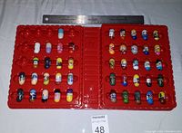 Open binder displaying 48 different Mighty Beanz figures in slots.