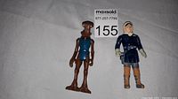 Photo of the 1978 Hammer Head and 1980 Han Solo Star Wars action figures side by side on white background with lot number card.