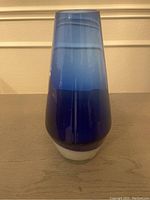 Front view of the glass vase showing blue to white gradient color transition and cylindrical shape.