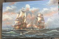 Front view of large oil/acrylic painting showing two historic sailing ships in battle with cannons firing and smoke, turbulent sea, cloudy sky with warm tones, signed J Harvey.