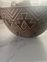 Side view showing the geometric tribal pattern on the bowl's exterior.