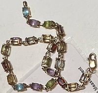 Entire bracelet laid flat showing all gemstone links and lobster clasp