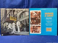 Front covers of Ace Spectrum Low Rent Rendezvous and Brownie & Sonny vinyl records lying flat on dark blue cloth.