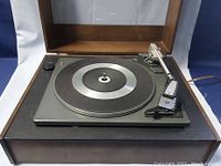 Front angled view of Garrard SP 25 MK II turntable on wooden base showing platter and tonearm.