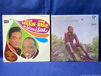 Front covers of the Jackie Wilson & Count Basie and Sonny Boy Williamson vinyl records displayed side-by-side on blue background.