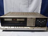 Front view of the JVC JR-S301 stereo receiver showcasing the analog meters, tuner dial, push buttons, and 5-band graphic equalizer panel.