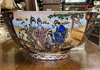 Side view of the bowl showing hand painted scene of Japanese women in traditional garments and landscape.