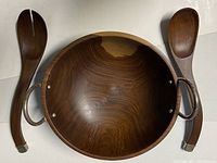 Top view of wooden salad bowl with sterling silver handles and pair of salad tongs