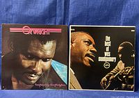 Photo showing two vinyl records in plastic sleeves, O.V. Wright on left and Wes Montgomery on right.