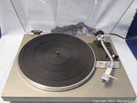Front view of the Technics SL-20 turntable showing the platter, tonearm, and cartridge.