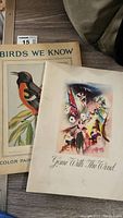 Top view of Birds We Know booklet and Gone With The Wind program showing front covers with color illustrations.