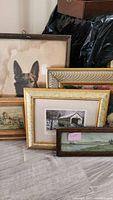 Five framed vintage wall art pieces arranged together, showing a variety of styles and frames.