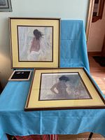 Two George E. Porter framed prints showing nude feminine silhouettes with beige mats on a blue cloth background.