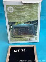 Full product box displaying brand Victory Garden and image of mosquito net covering a sun shade area outdoors.