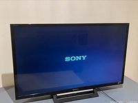 Front view of Sony Bravia TV powered on showing SONY logo on screen.
